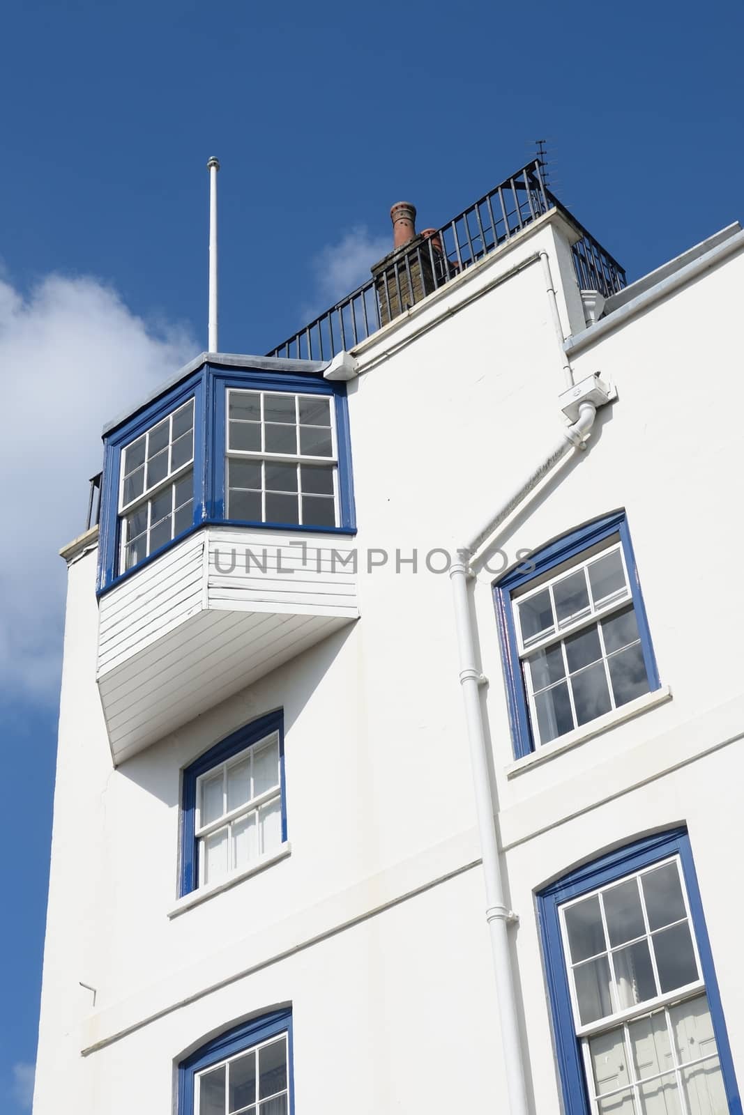 Looking up at large white house