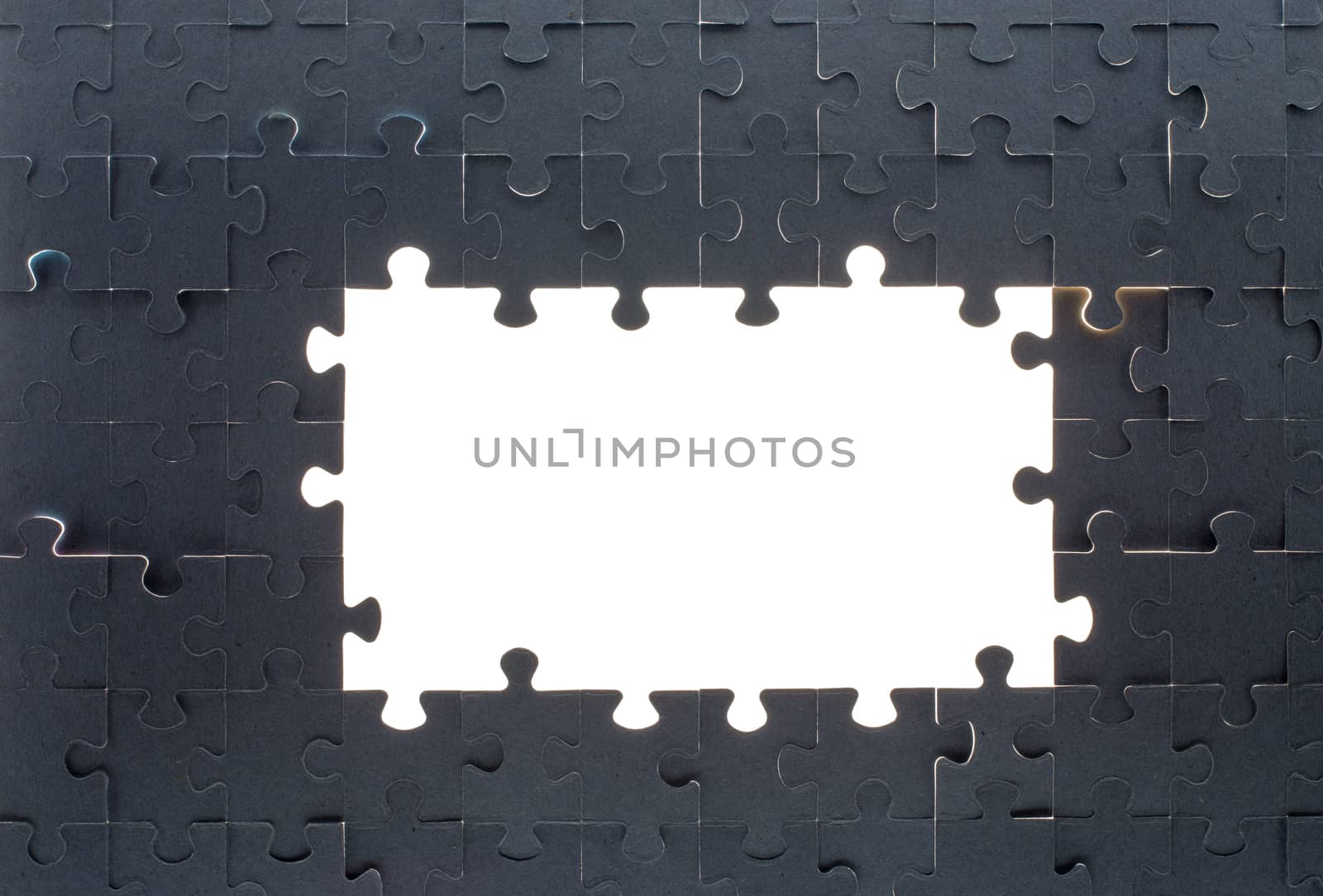 Grey puzzle background with big empty white space, top view