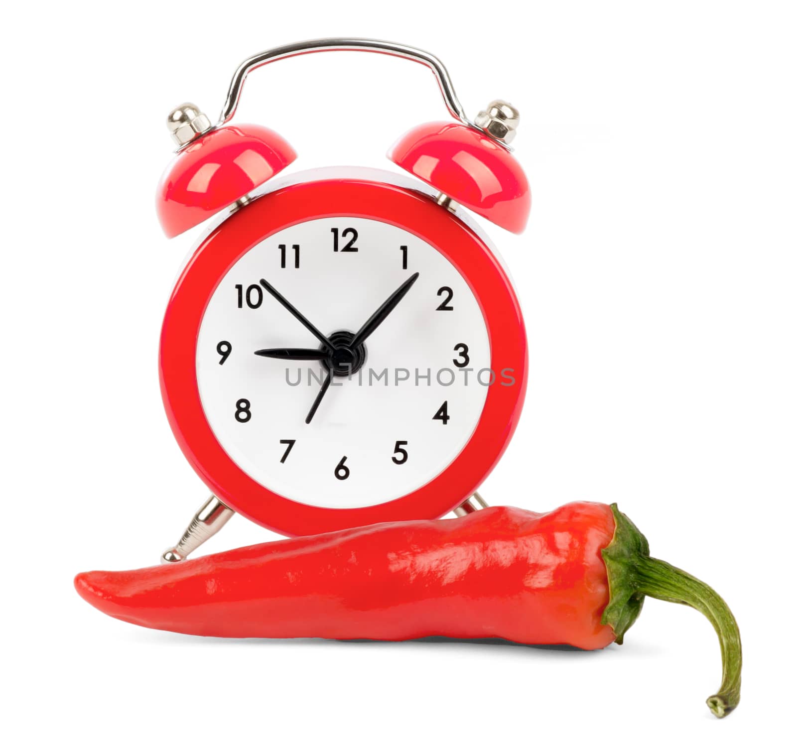 Red hot pepper with red alarm clock on isolated white background