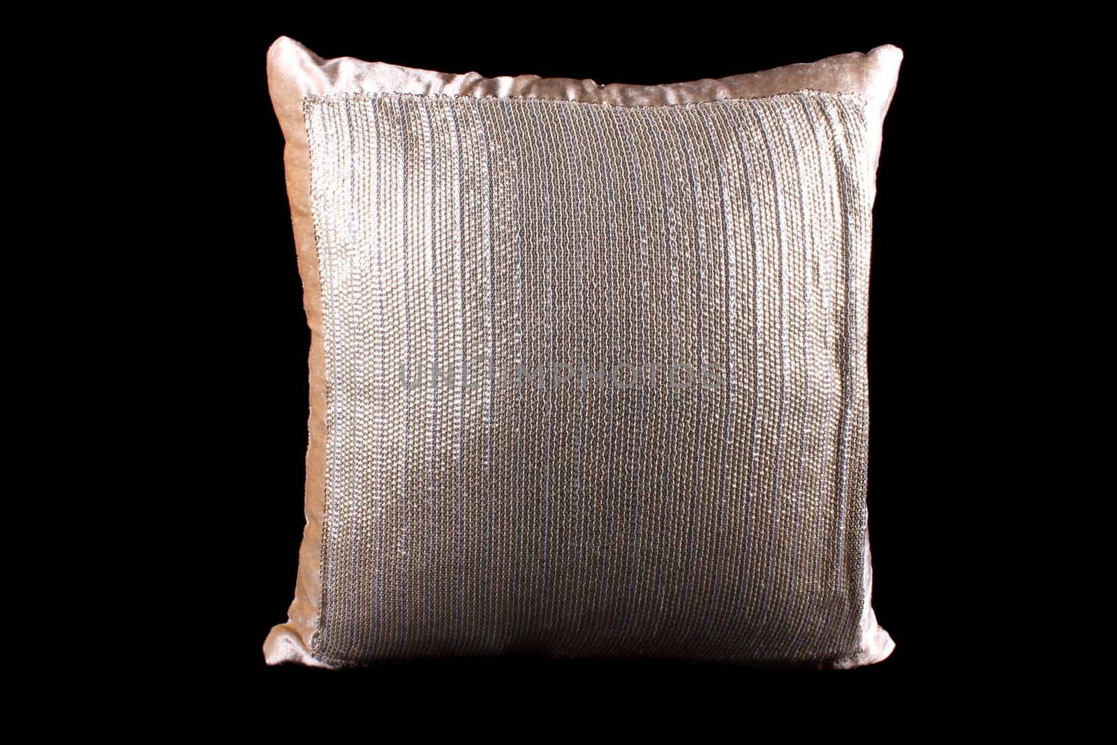 A golden and silver colored shiny pillow with sequins on black studio background.
