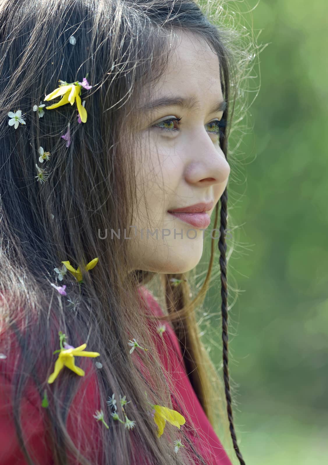 Beautiful girl with flowers in her hair in spring time