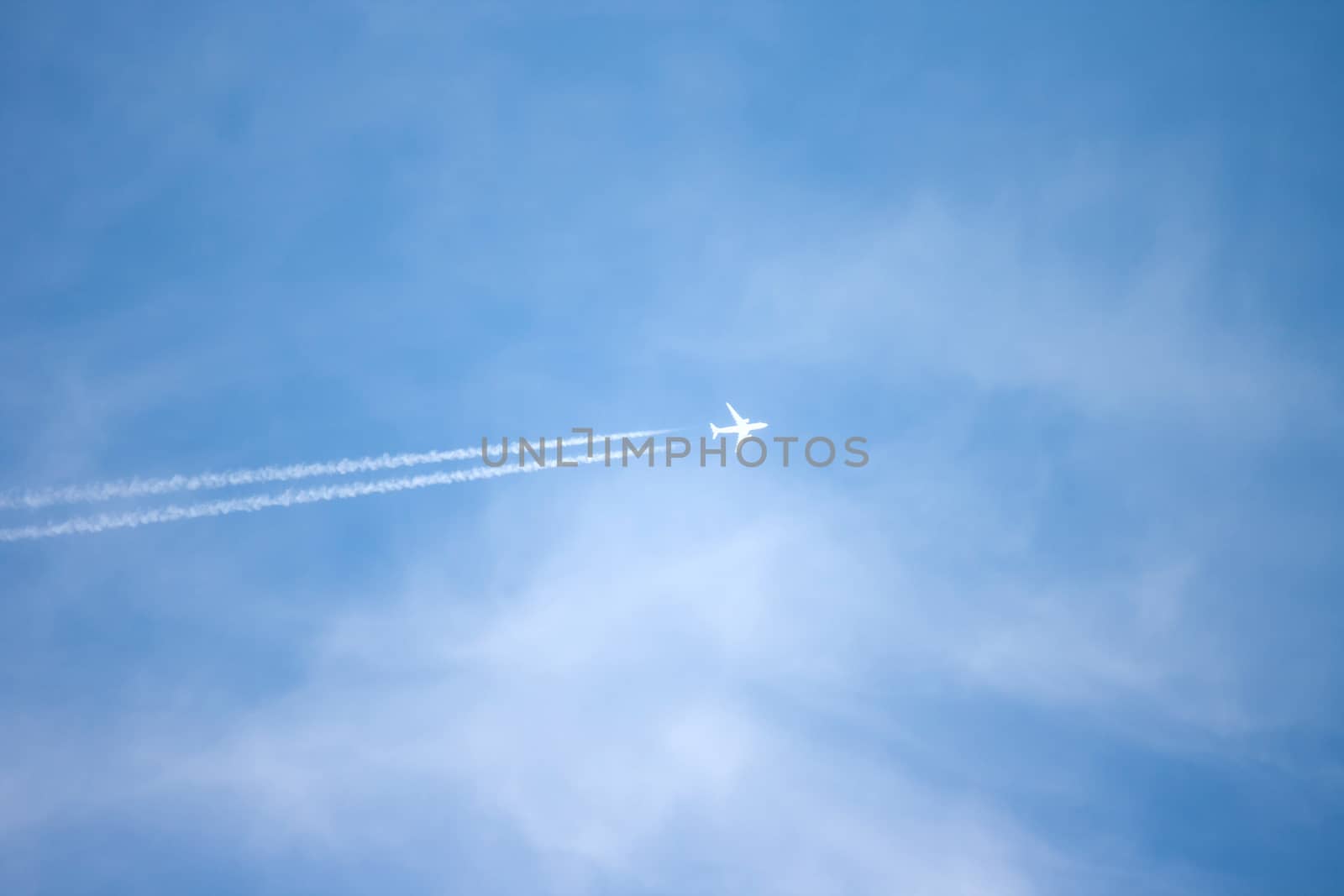 A long trail of jet plane on blue sky