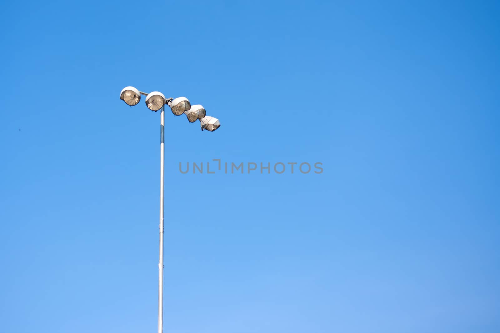 Spot light tower in blue sky