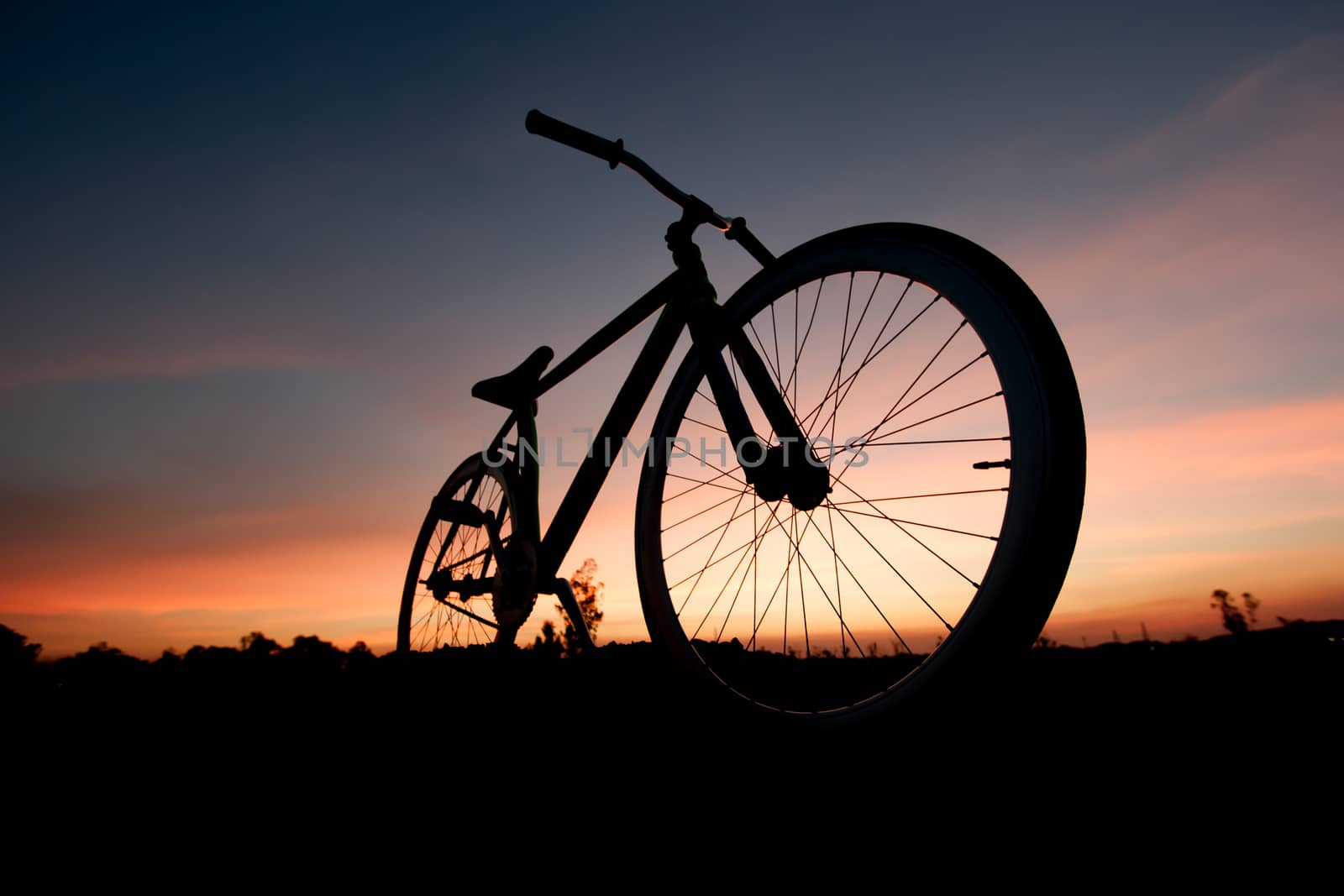 silhouette bicycle in sunset by pkproject