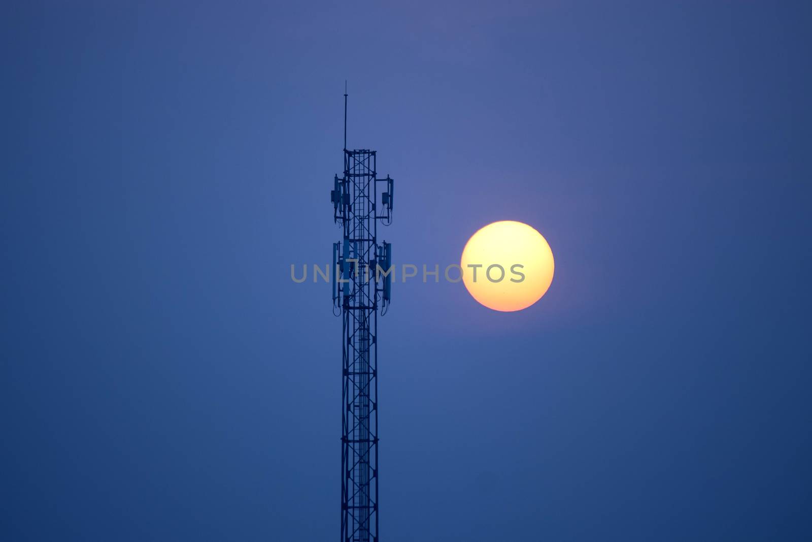 Silhouette of communication tower at sunset