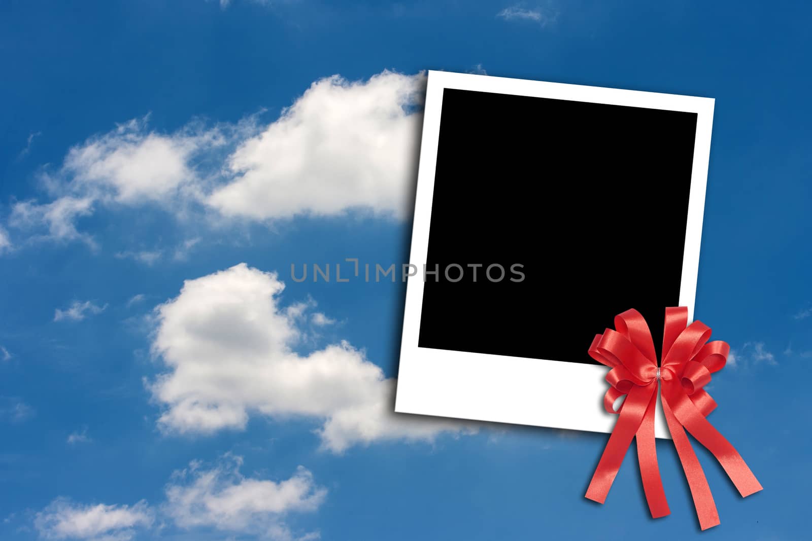 Photo frame on blue sky background