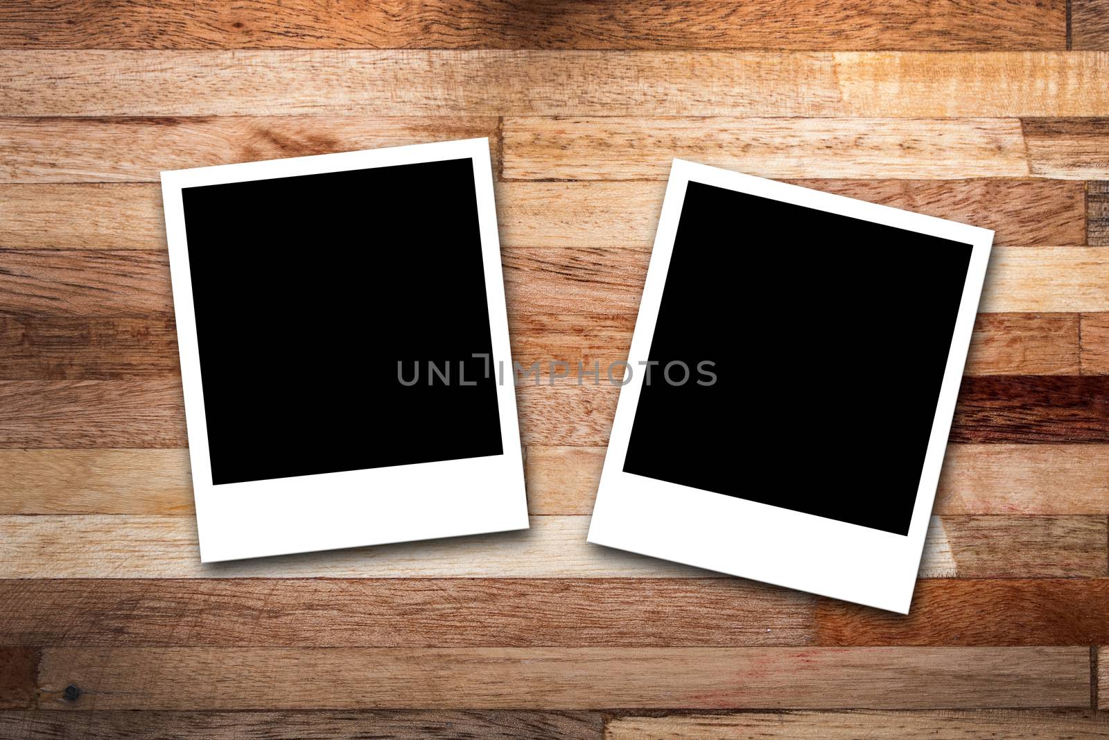 Blank photo frames on wood background