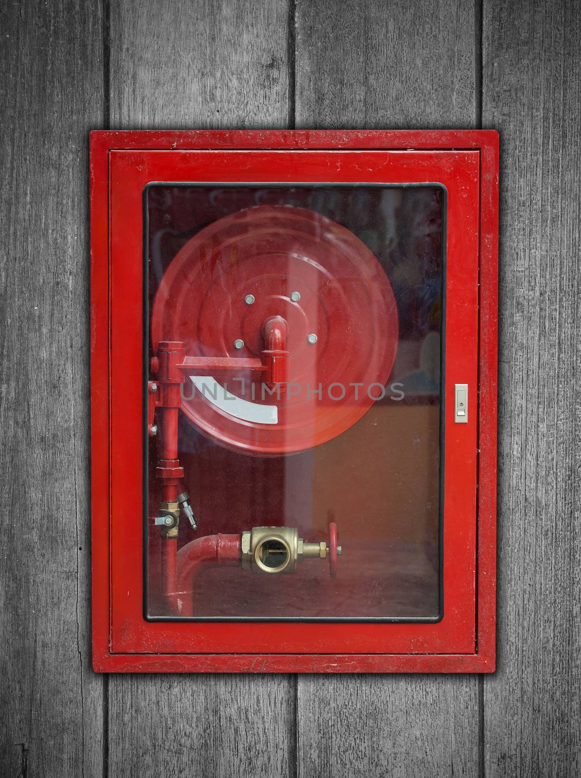 Red Fire Hose Cabinet on wood background