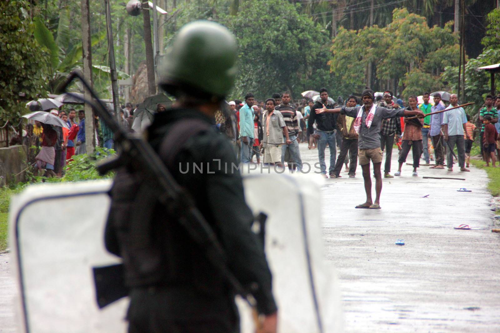 INDIA, Tinsukia: An officer stands guard after a protest where at least eleven people were killed, and twelve others injured, when a high-voltage electric cable was hit by stray police fire and fell on protesters in Tinsukia, Assam, India on April 11, 2016. Protesters had reportedly stormed a police station, calling on police to hand over a group of suspects arrested for killing two people last week. Police opened fire to disperse protesters, and a stray bullet severed the power line, which fell and electrocuted demonstrators.