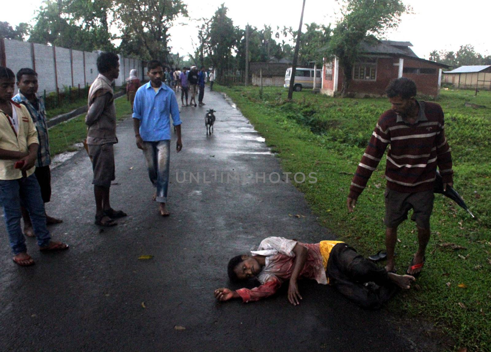 INDIA, Tinsukia: [WARNING: graphic content] A man lies bloodied on the ground after a protest where at least eleven people were killed, and twelve others injured, when a high-voltage electric cable was hit by stray police fire and fell on protesters in Tinsukia, Assam, India on April 11, 2016. Protesters had reportedly stormed a police station, calling on police to hand over a group of suspects arrested for killing two people last week. Police opened fire to disperse protesters, and a stray bullet severed the power line, which fell and electrocuted demonstrators.