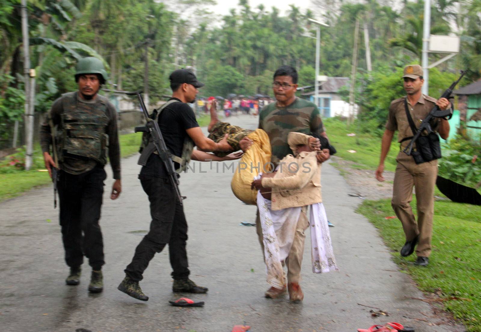 INDIA, Tinsukia: [WARNING: graphic content] Officers carry a man's body after a protest where at least eleven people were killed, and twelve others injured, when a high-voltage electric cable was hit by stray police fire and fell on protesters in Tinsukia, Assam, India on April 11, 2016. Protesters had reportedly stormed a police station, calling on police to hand over a group of suspects arrested for killing two people last week. Police opened fire to disperse protesters, and a stray bullet severed the power line, which fell and electrocuted demonstrators.