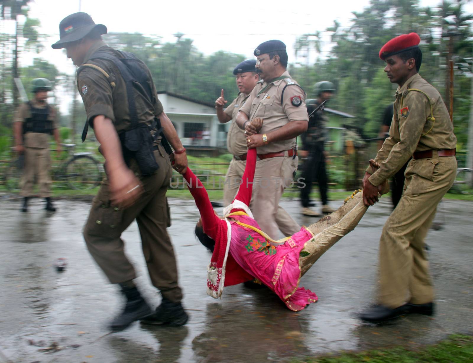 INDIA, Tinsukia: [WARNING: graphic content] Officers carry a woman's body after a protest where at least eleven people were killed, and twelve others injured, when a high-voltage electric cable was hit by stray police fire and fell on protesters in Tinsukia, Assam, India on April 11, 2016. Protesters had reportedly stormed a police station, calling on police to hand over a group of suspects arrested for killing two people last week. Police opened fire to disperse protesters, and a stray bullet severed the power line, which fell and electrocuted demonstrators.