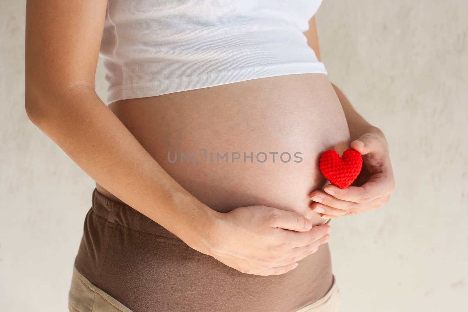 Pregnant woman holding her hand on belly by pkproject