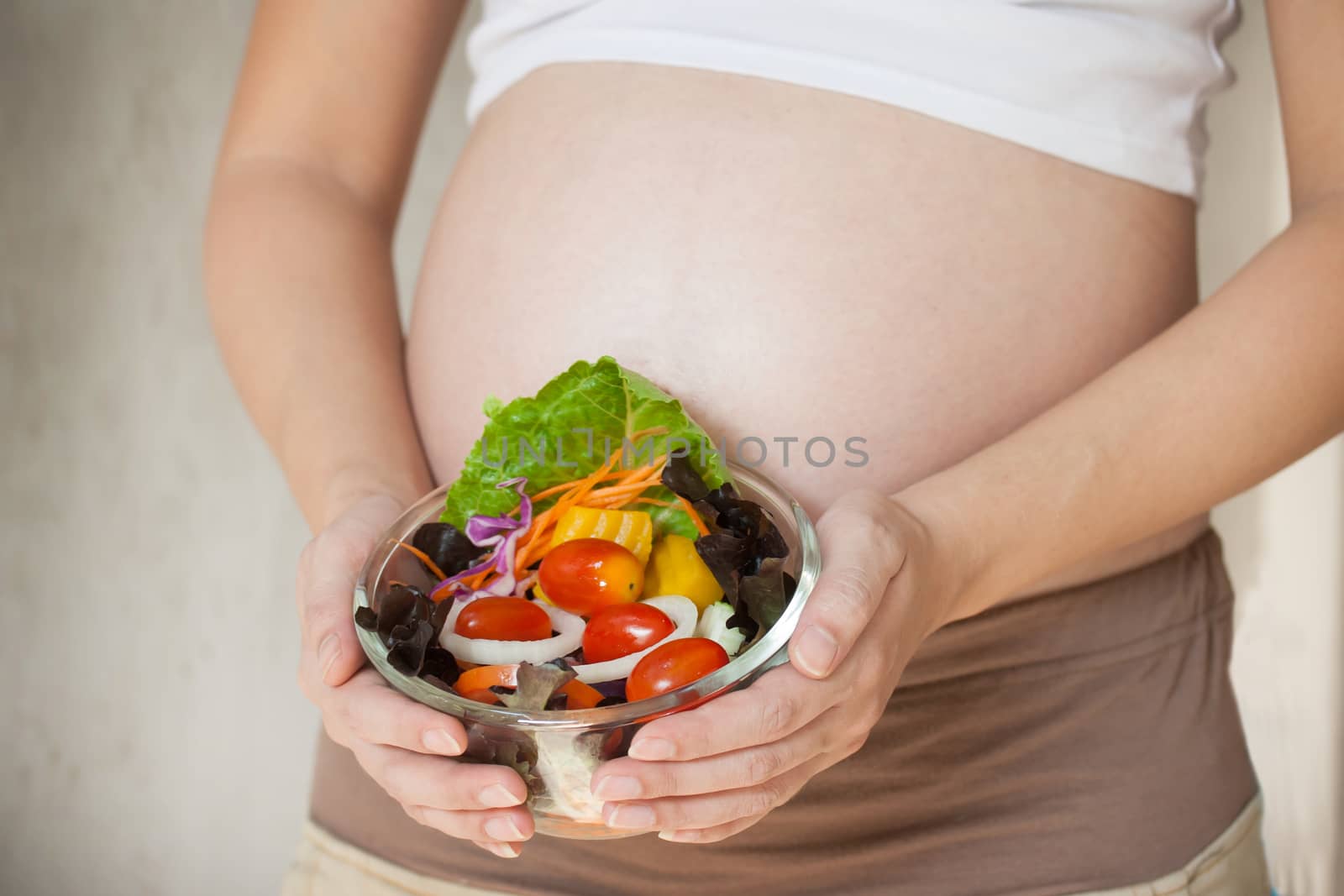 Pregnant woman's belly and vegetable salad by pkproject