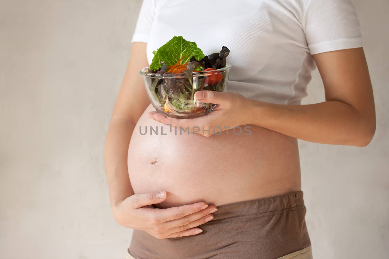 Pregnant woman's belly and vegetable salad by pkproject