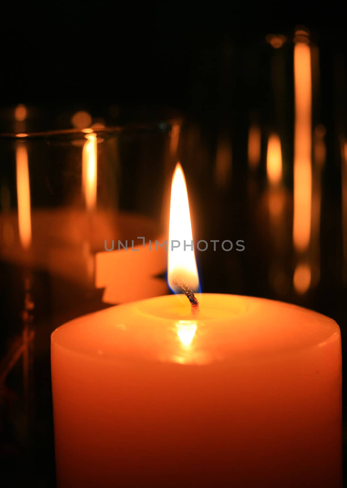A One candle flame at night closeup