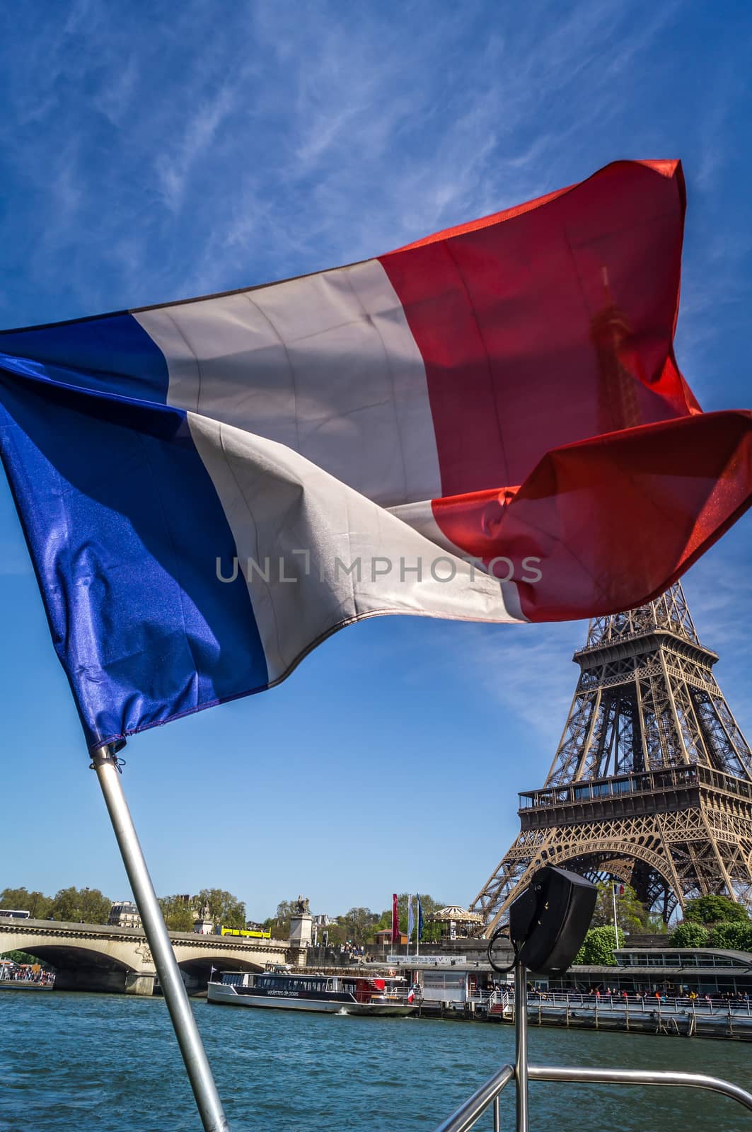 French flag floating in front of the eiffel tower