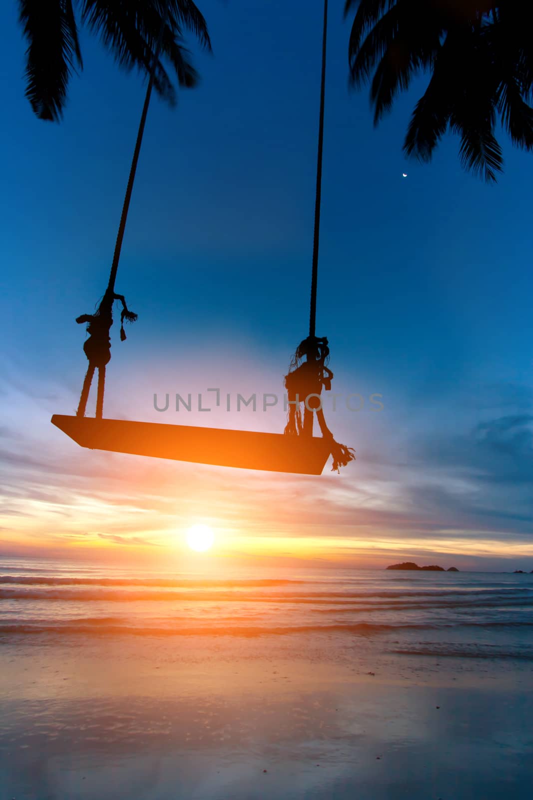 Empty Swing and Sunlight on the Beach