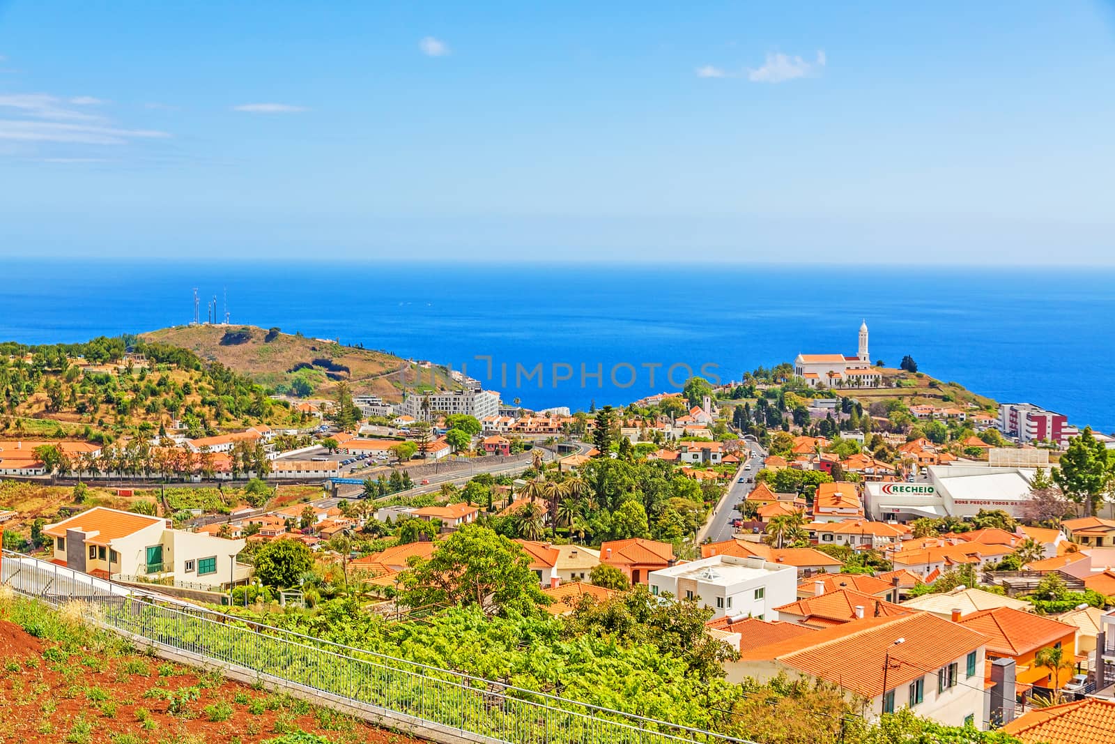 Funchal, Madeira - June 7, 2013: Church of Sao Martinho - a civil parish in the municipality of Funchal. View from Pico dos Barcelo - south coast of Madeira - Atlantic Ocean in the background.