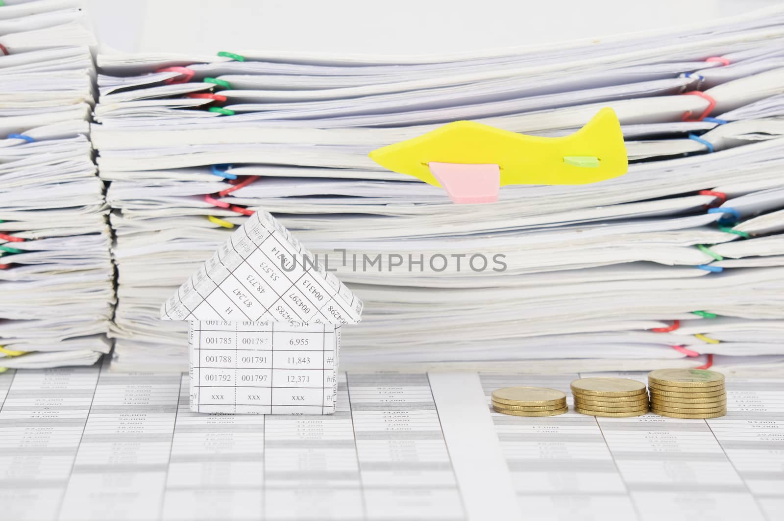 Airplane fly over house and  step pile of gold coins on finance account  have stack overload document of receipt and report with colorful paperclip as background.