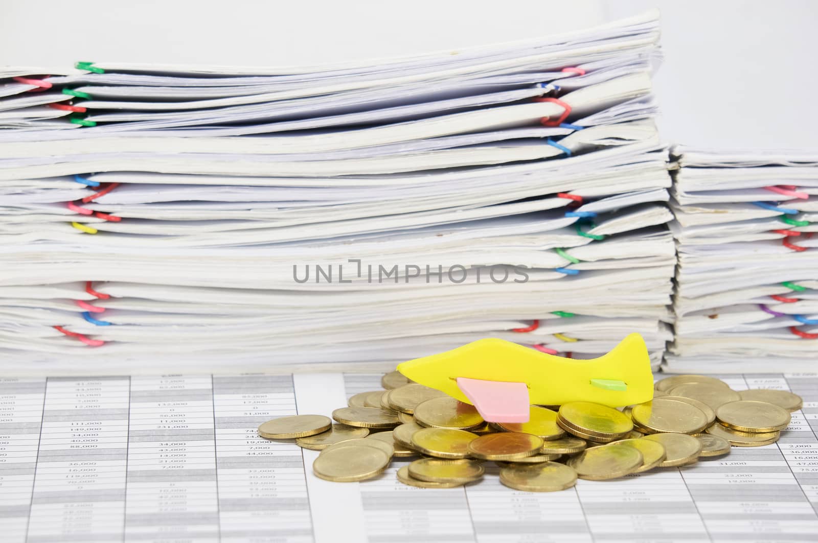 Airplane on stack of gold coins on finance account  have stack overload document of receipt and report with colorful paperclip as background.