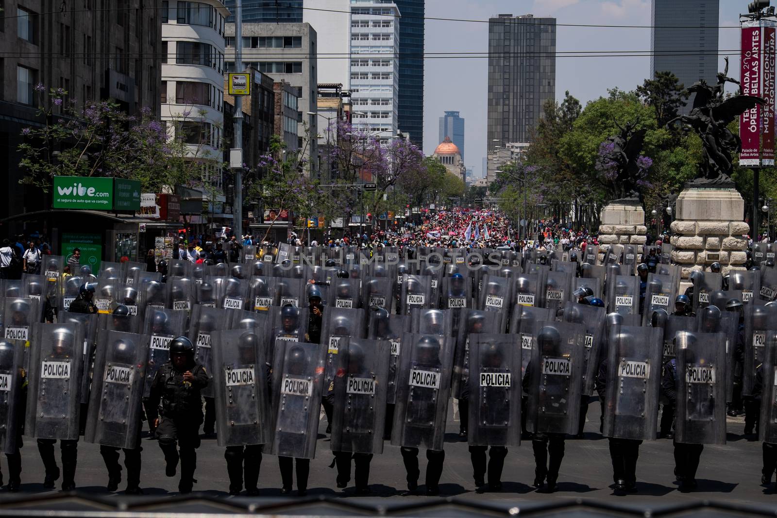 MEXICO, Mexico City: Mexican riot police face hundreds of protesters who march through Mexico City on April 11, 2016 — the day following revolutionary Emiliano Zapata's death anniversary — to draw attention to desires of several indigenous communities. Campesinos, people who live in the rural areas- from all Mexican states, came to the capital to express their discontent with the government. The demonstration was also held to commemorate the famous revolutionary Emilio Zapata.