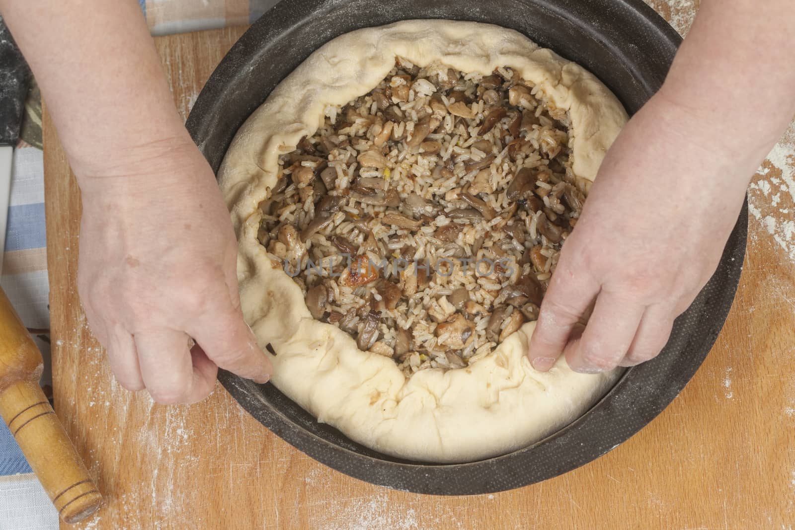 Putting filling on raw dough by kozak