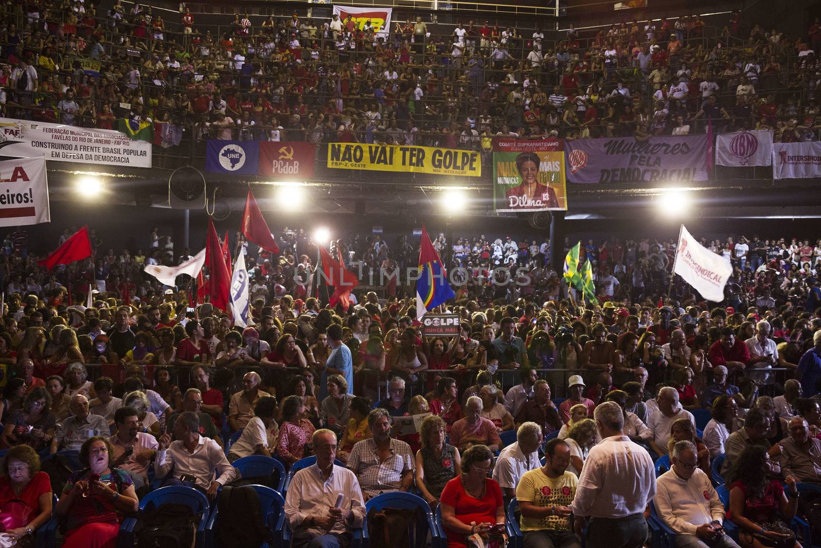 BRAZIL, Rio de Janeiro: People watch former President Luiz Inacio Lula da Silva (C), 'Lula', speak at a rally supporting President Dilma Rousseff in the historic Lapa neighborhood on April 11, 2016 in Rio de Janeiro, Brazil. Brazil's congressional impeachment committee approved the motion to proceed with President Dilma Rousseff's impeachment process today. A full vote by the lower house of Congress on the impeachment is scheduled for Sunday to decide whether she will face trial. 