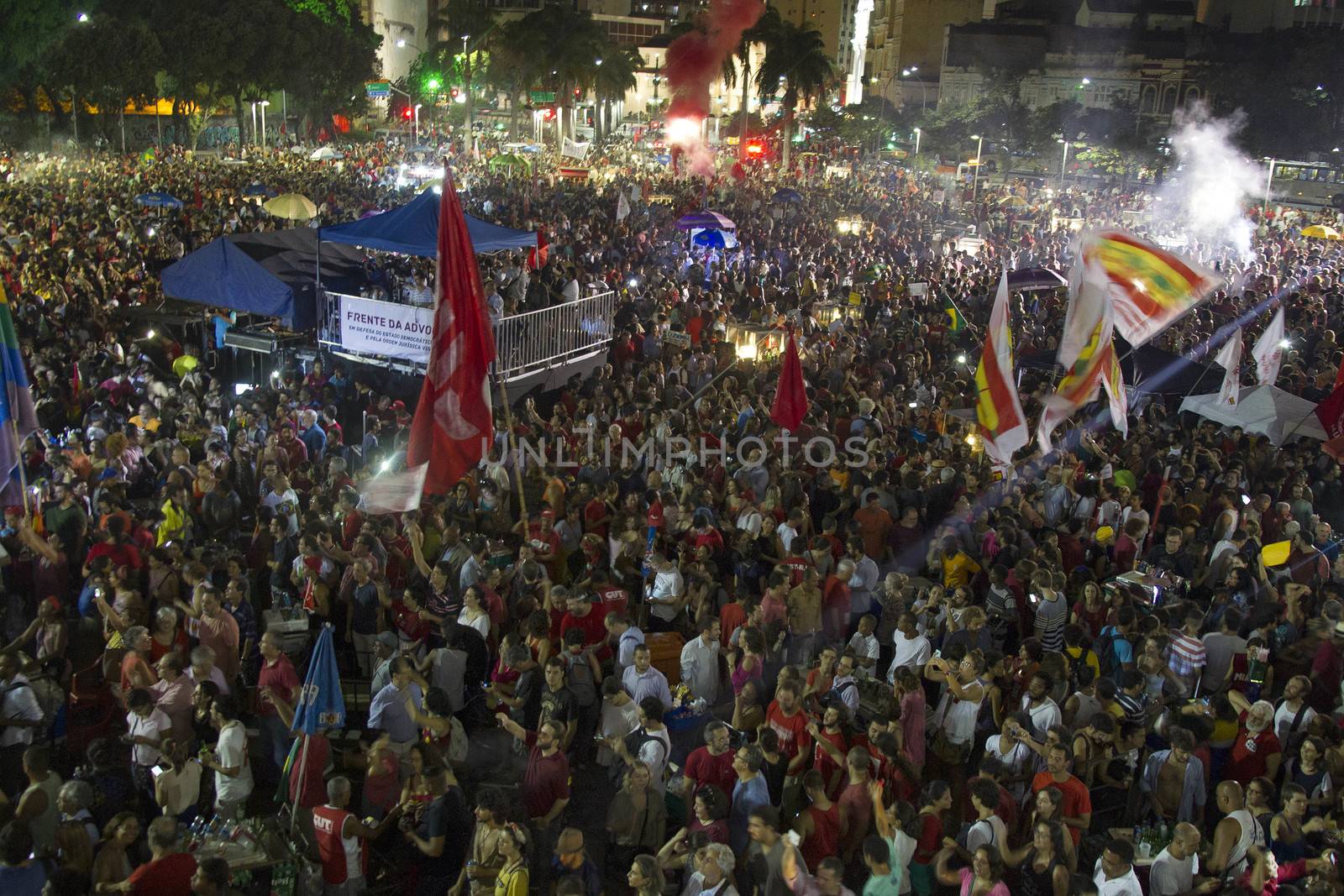 BRAZIL, Rio de Janeiro: People watch former President Luiz Inacio Lula da Silva (C), 'Lula', speak at a rally supporting President Dilma Rousseff in the historic Lapa neighborhood on April 11, 2016 in Rio de Janeiro, Brazil. Brazil's congressional impeachment committee approved the motion to proceed with President Dilma Rousseff's impeachment process today. A full vote by the lower house of Congress on the impeachment is scheduled for Sunday to decide whether she will face trial. 