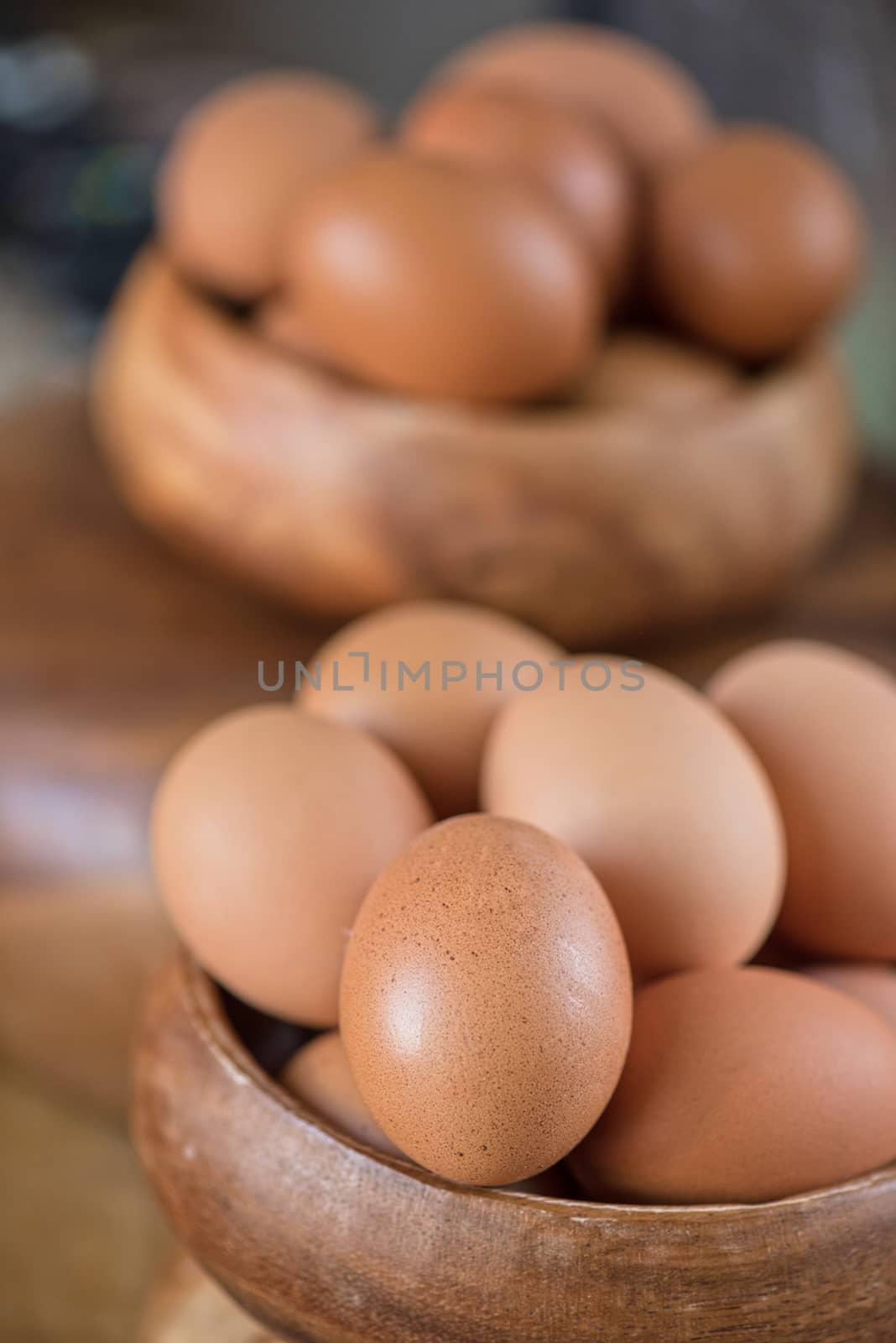 Fresh eggs at wooden plate closeup