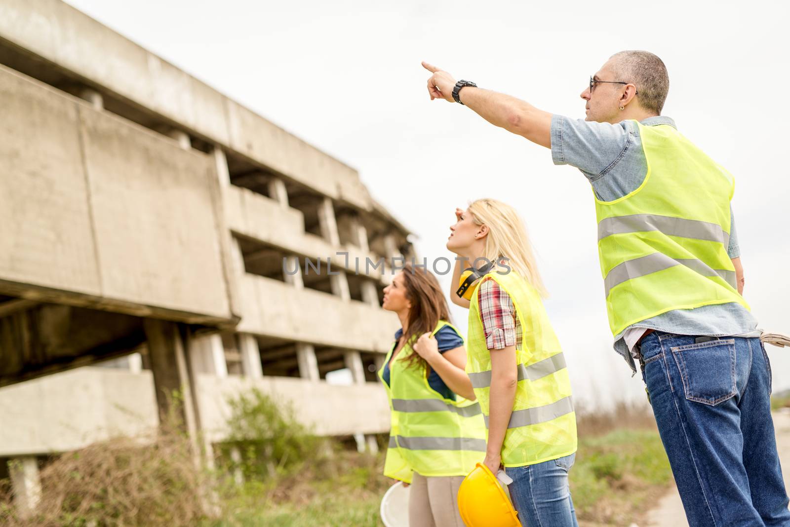 Construction architects in front building damaged in the disaster.