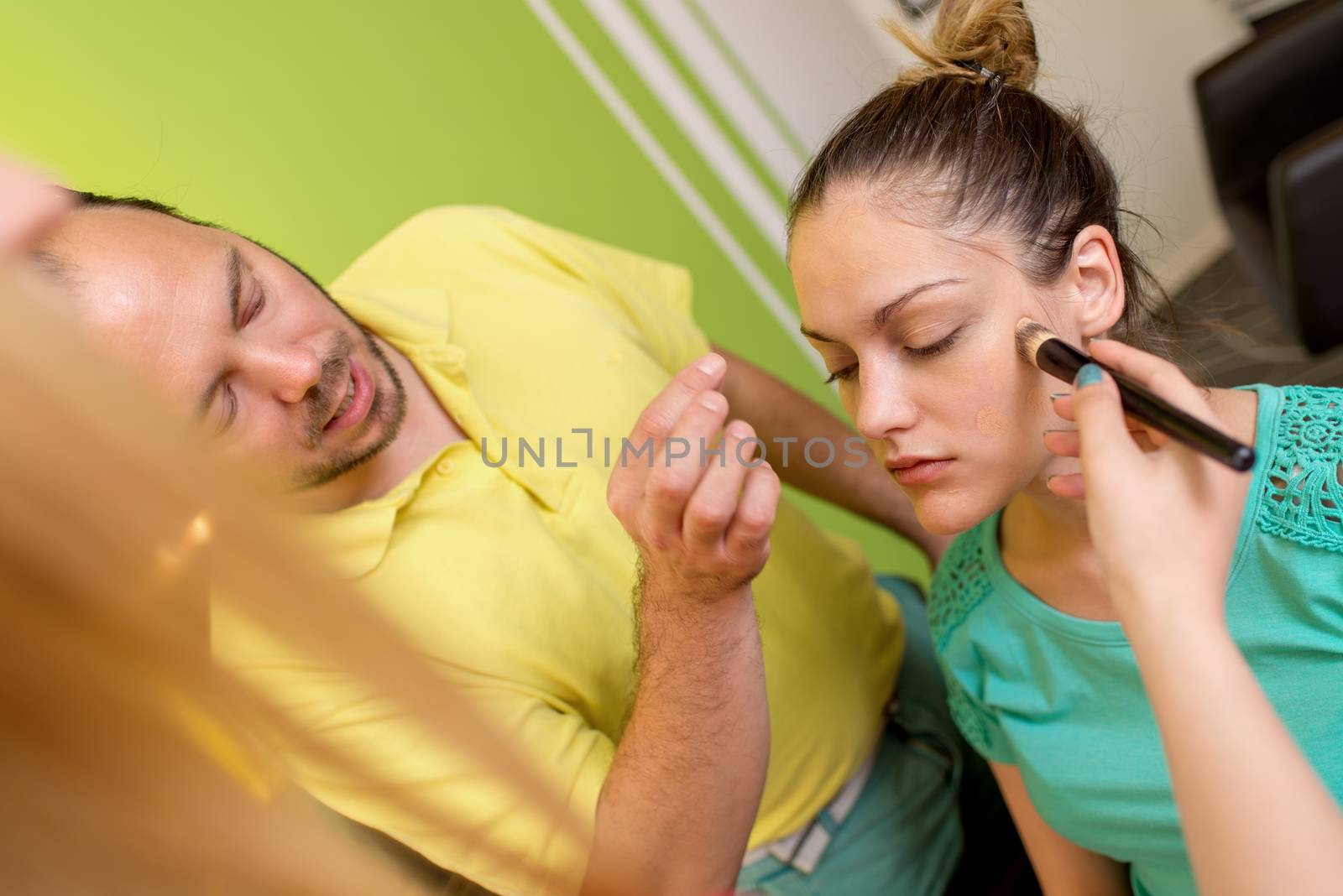 Makeup teacher helping students training to become makeup artist