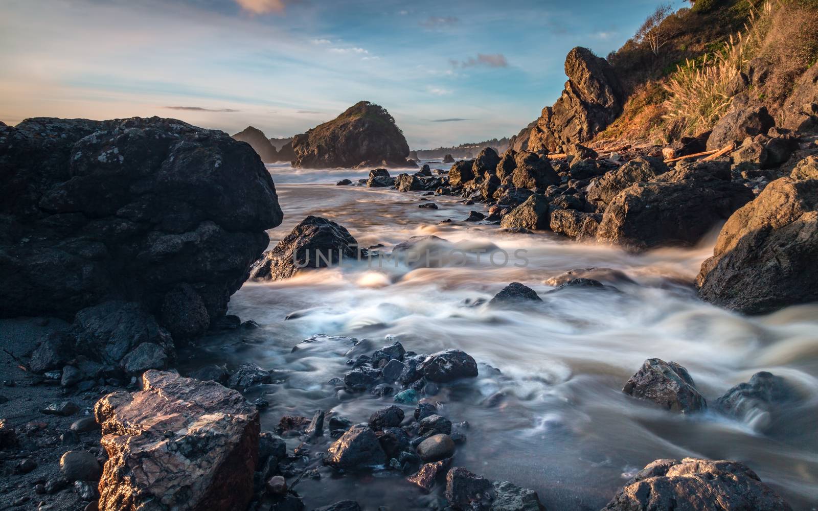 Long-exposure color image of the Pacific coastline at Sunset 