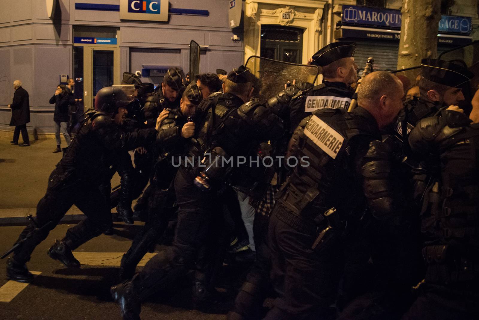 FRANCE, Paris: French police officers face protesters during a night demonstration in front of a police station in the 2nd arrondissement of Paris, on April 12, 2016. Protesters claim the release of a student arrested earlier in the day. 