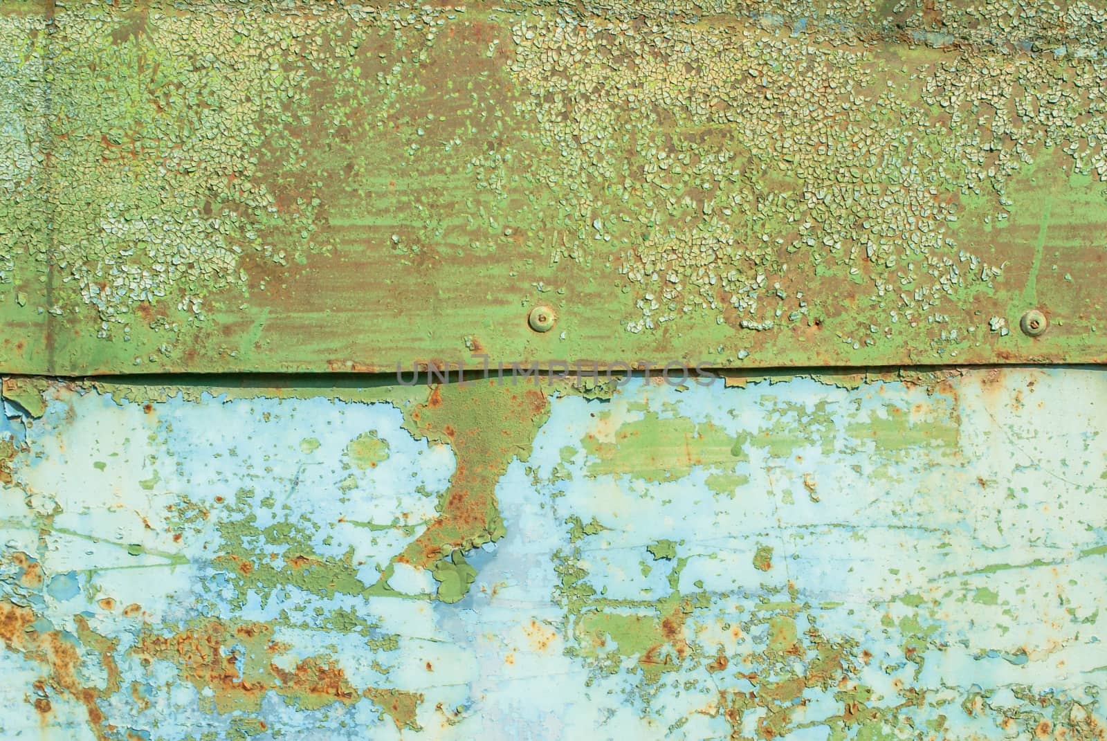 fragment of an iron surface is covered with emerald and blue color paint, which has long been under the influence of different climatic conditions