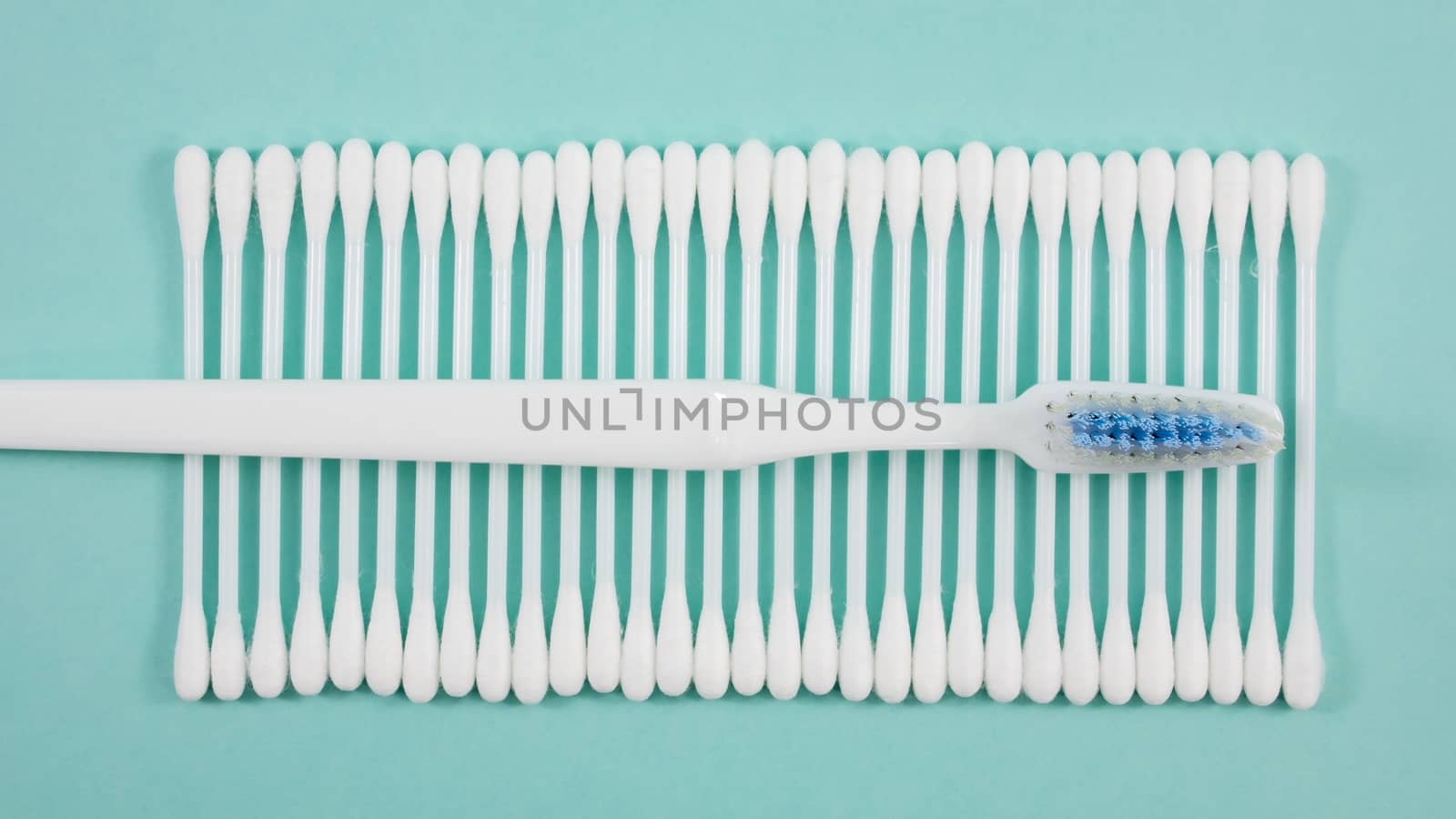 The group of purified white cotton buds with the white toothbrush.