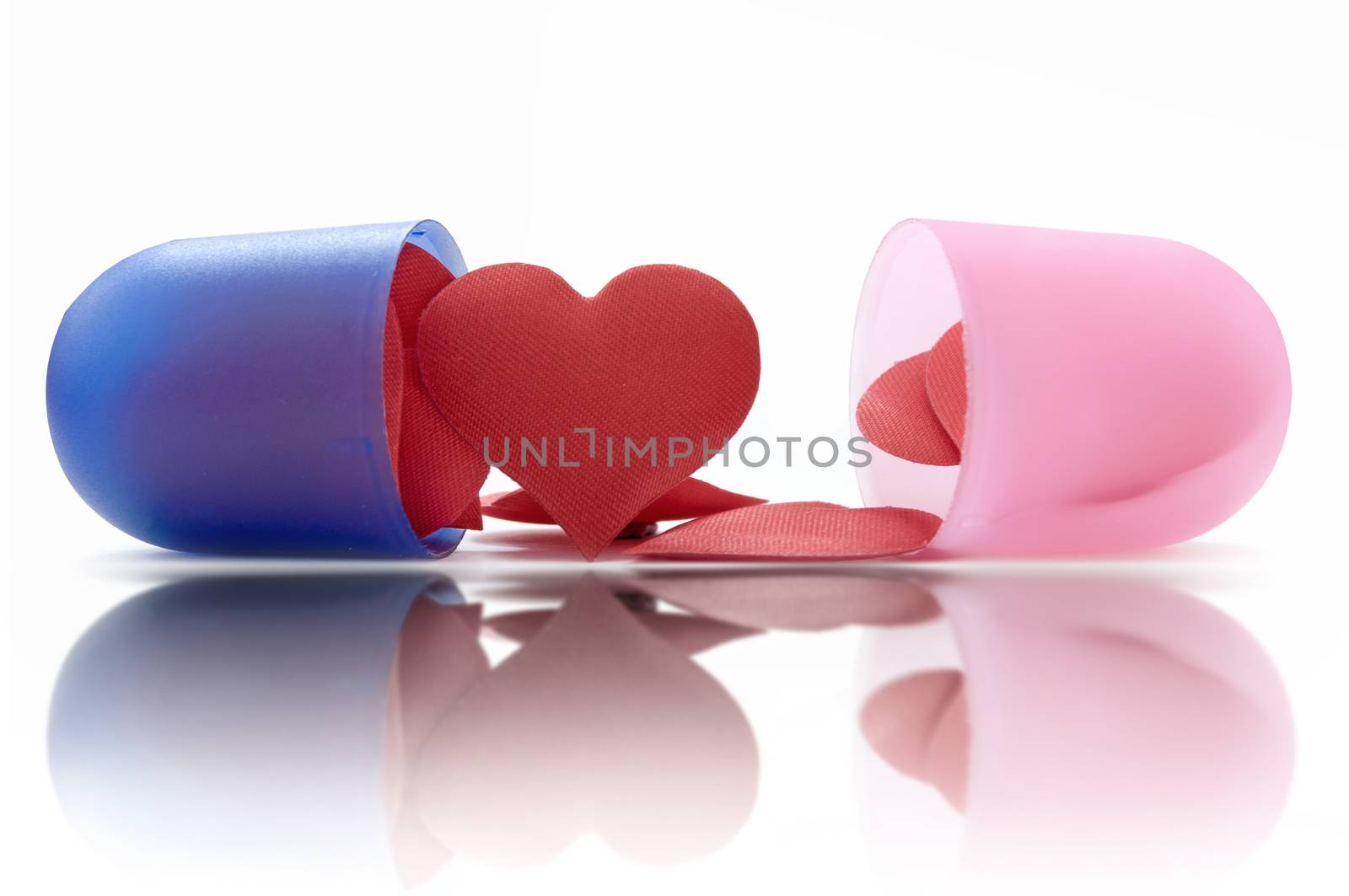 Heart shape pills inside a medicine pill capsule