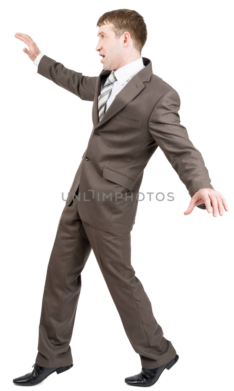 Businessman on tiptoes isolated on white background