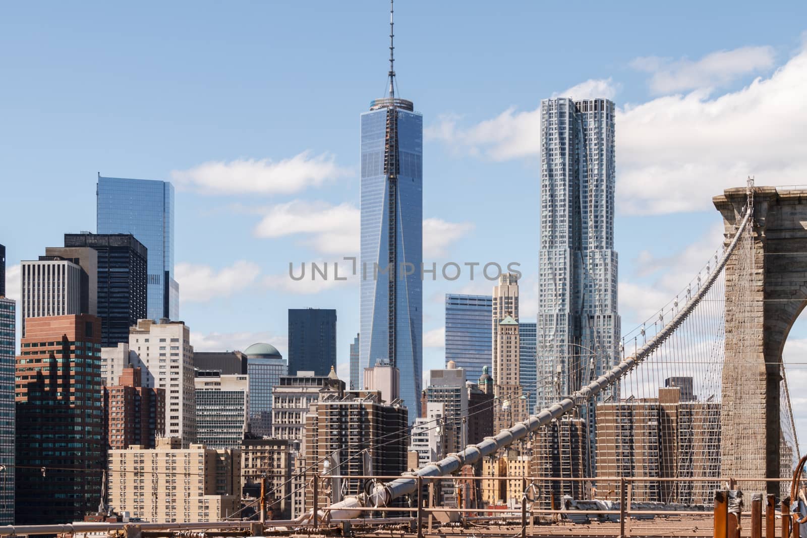 The view of the skyscrapers of lower Manhattan, New York, as seen from the Brooklyn Bridge, being under constant construction