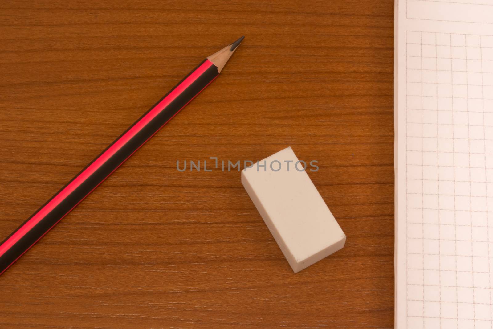 Wooden table with pencil, notebook and eraser