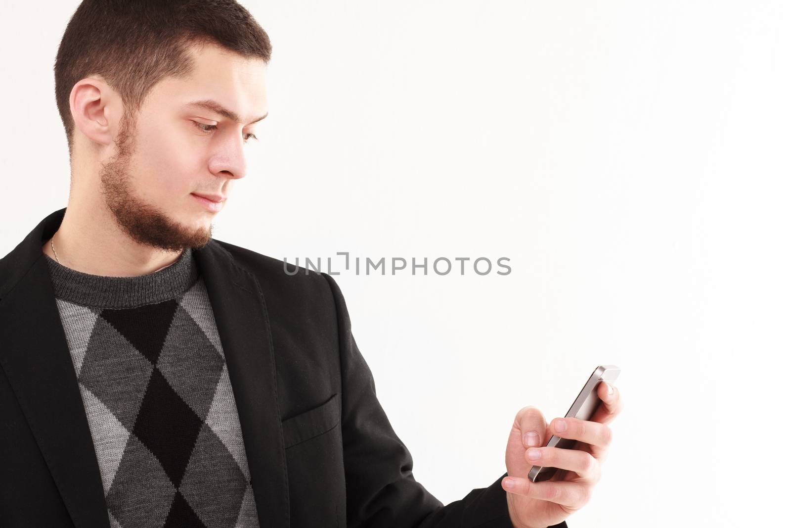 Casual businessman using his phone isolated on white