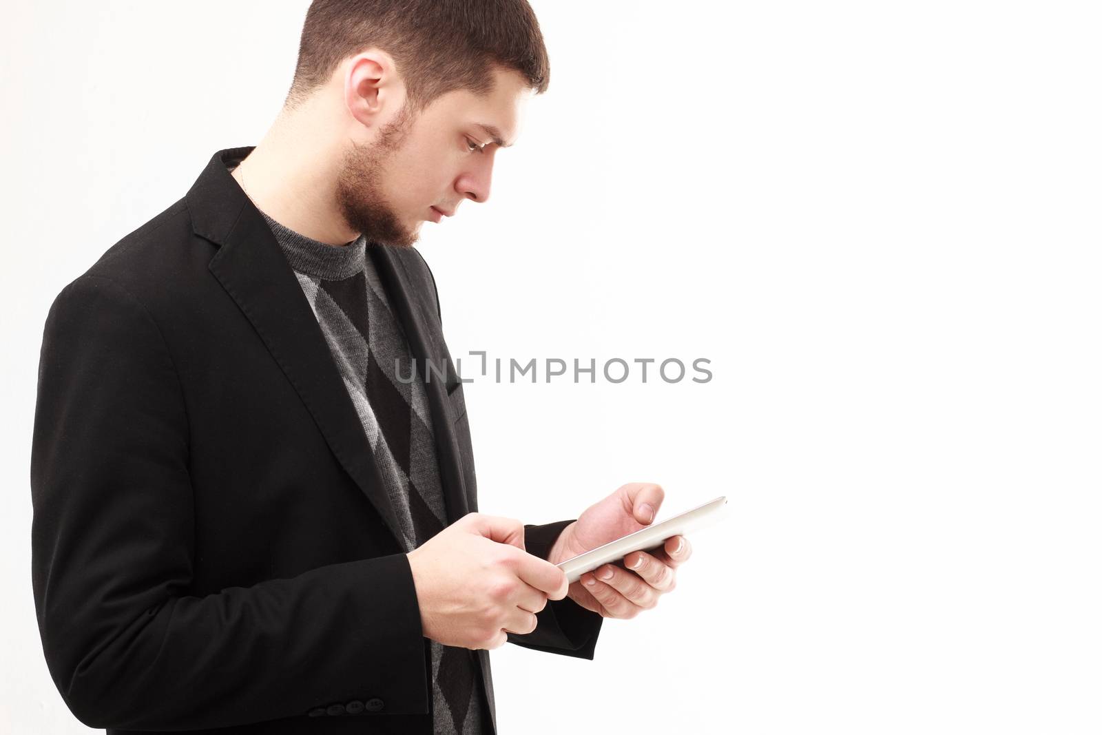 Casual businessman using his tablet  isolated on white