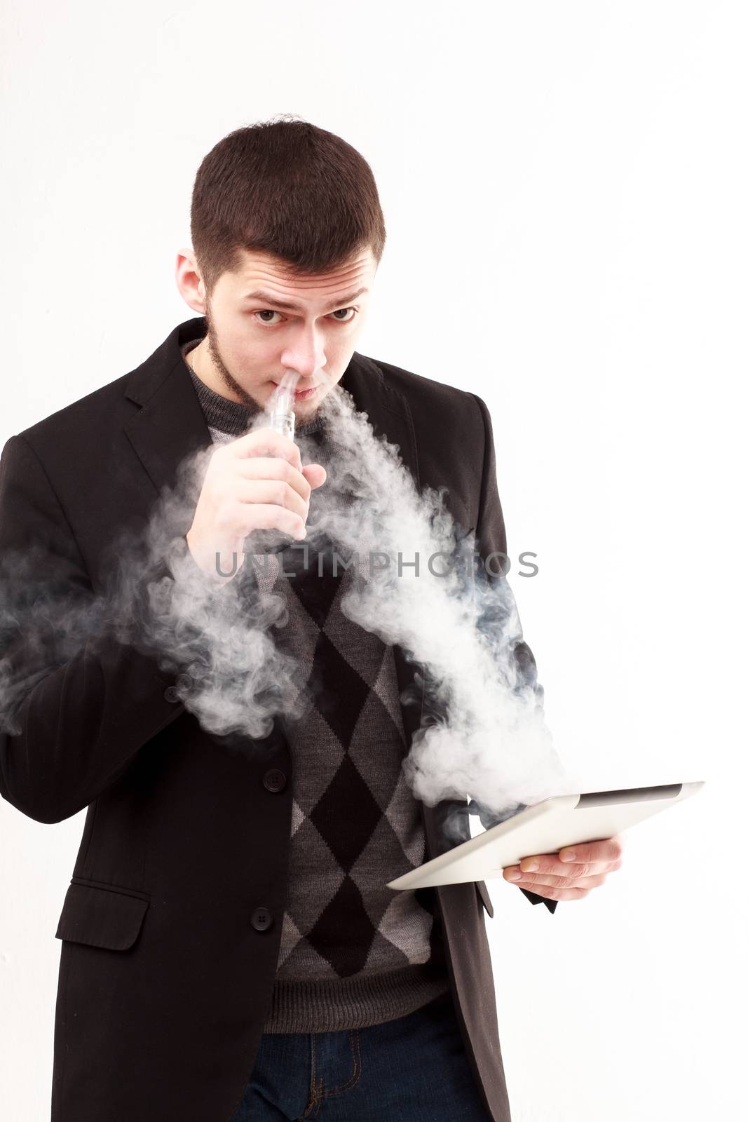 Vaping casual businessman using his tablet isolated on white looking in camera