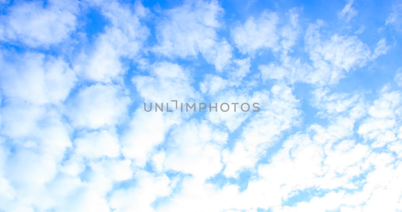 Blue sky with tiny clouds