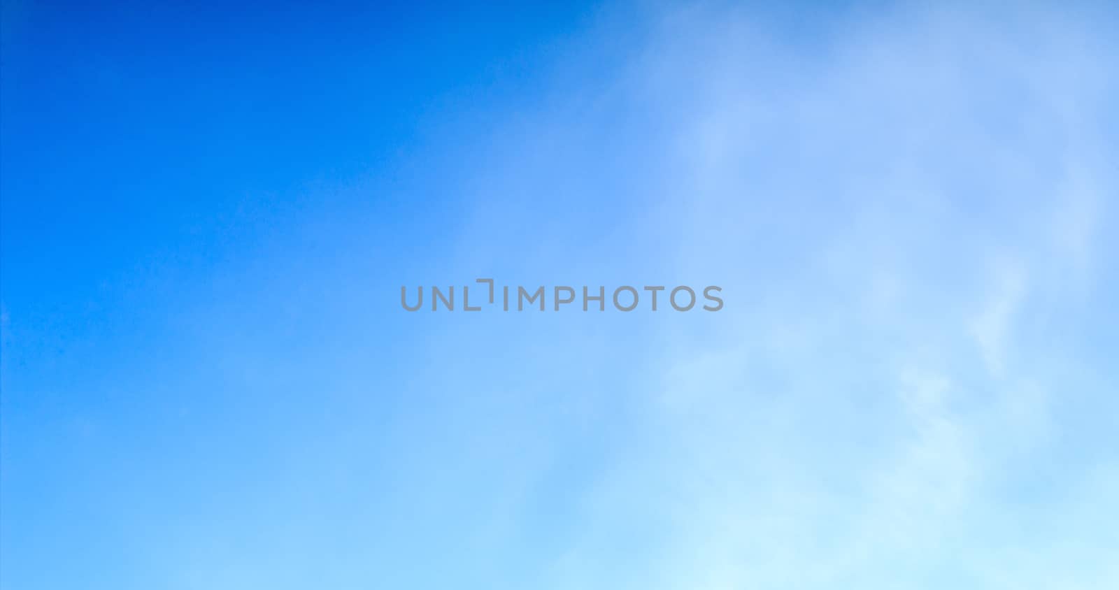 Blue sky with tiny clouds