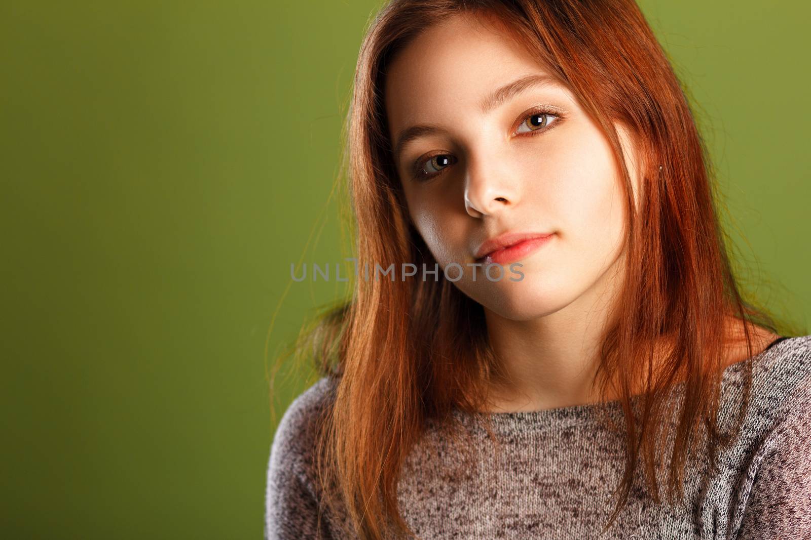 Portrait of teenage girl on green background