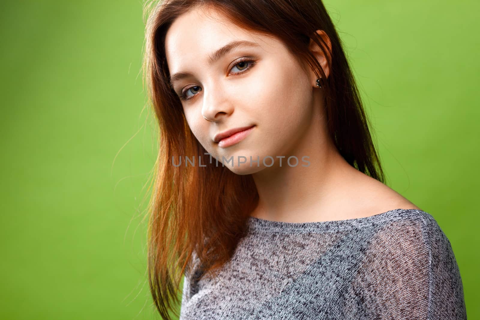 Portrait of teenage girl on green background