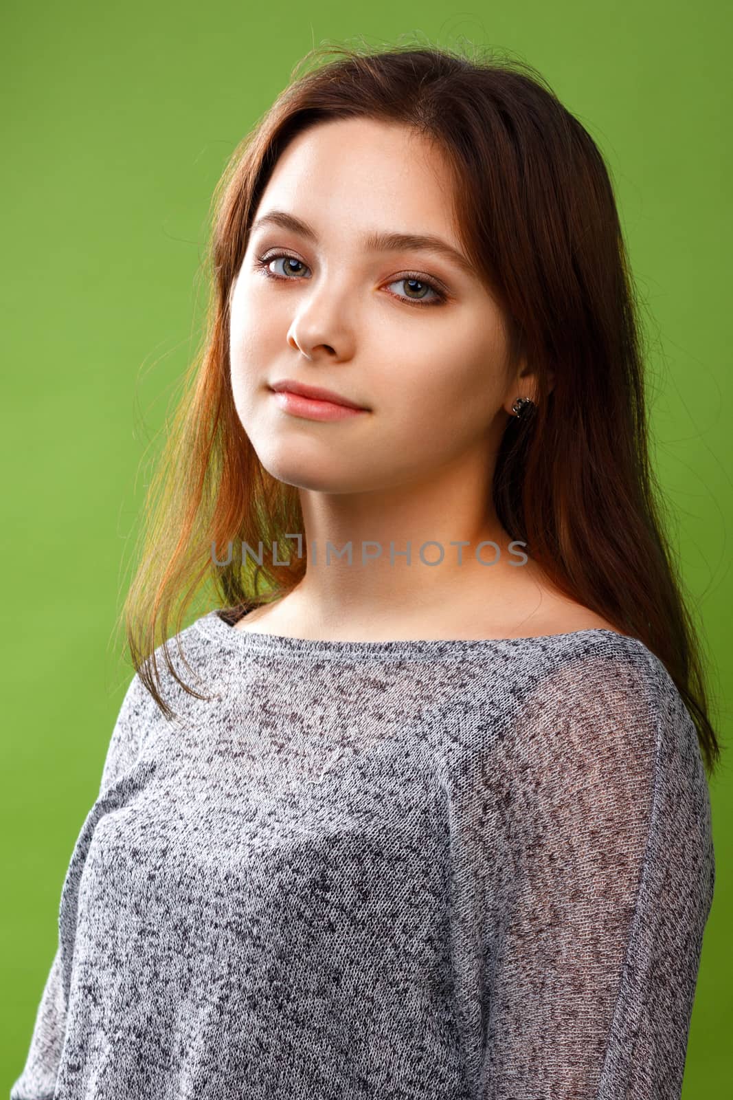 Portrait of teenage girl on green background