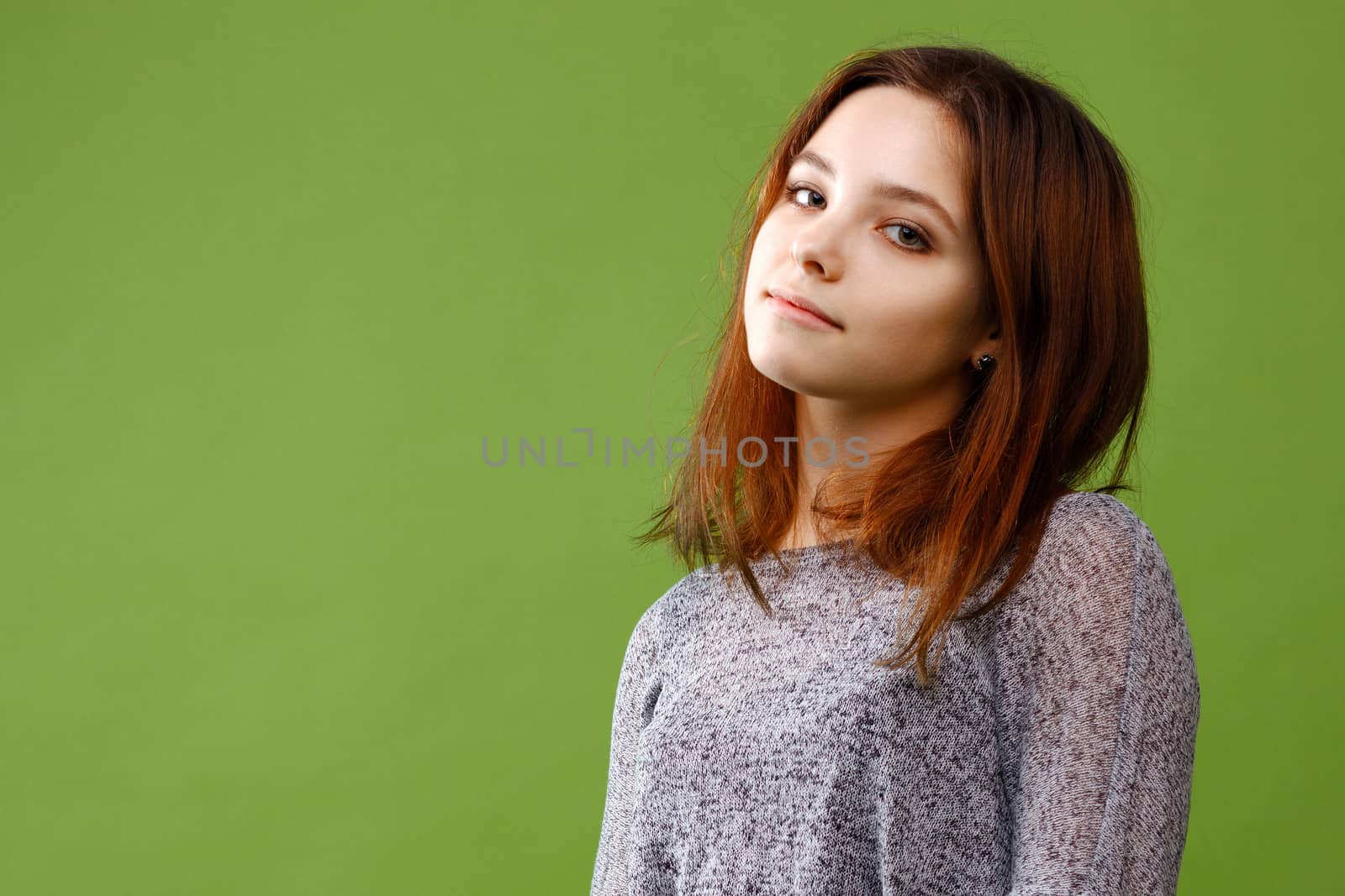 Portrait of teenage girl on green background