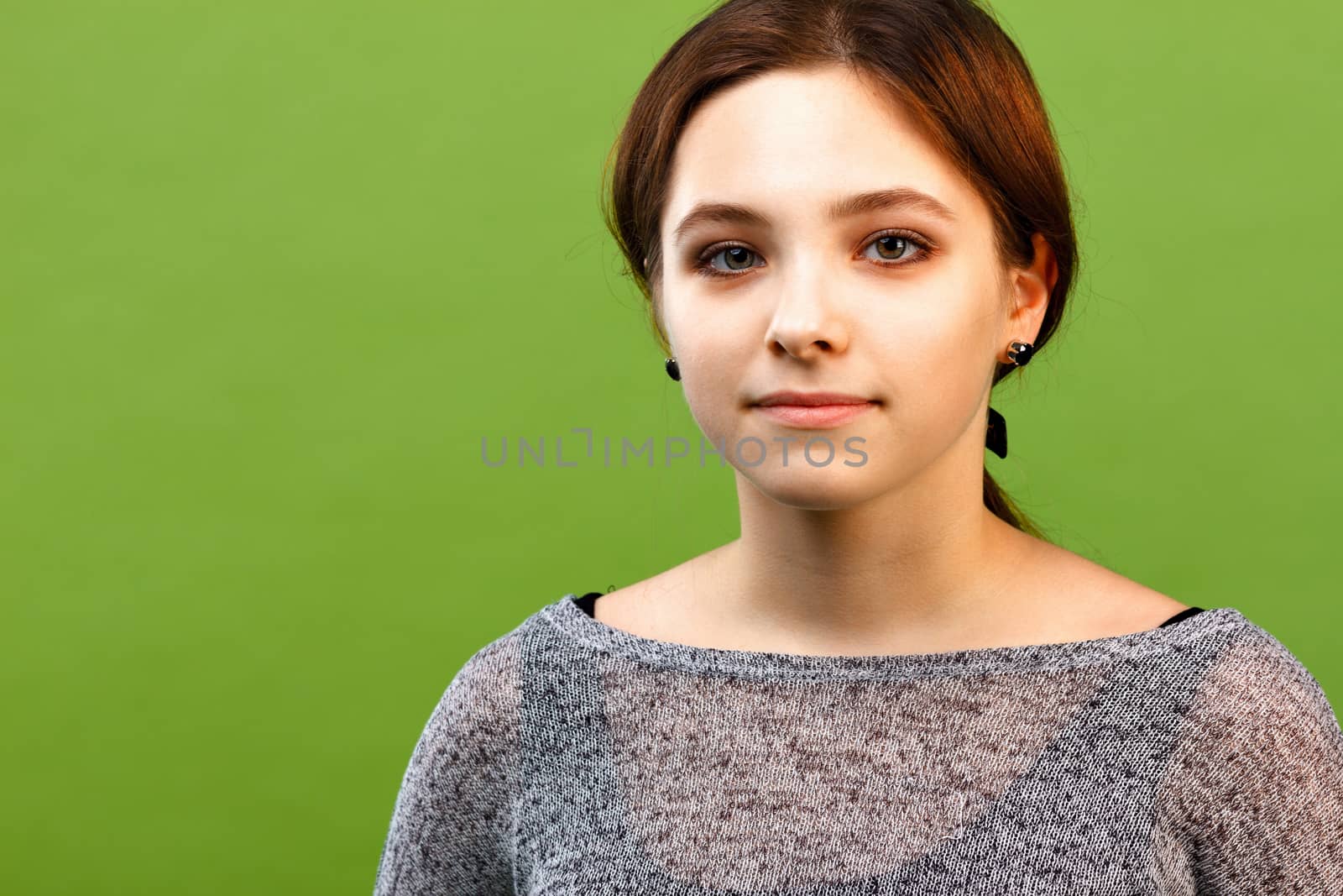 Portrait of teenage girl on green background